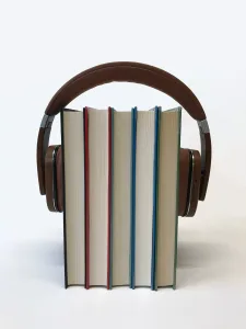 headphones around a stack of books