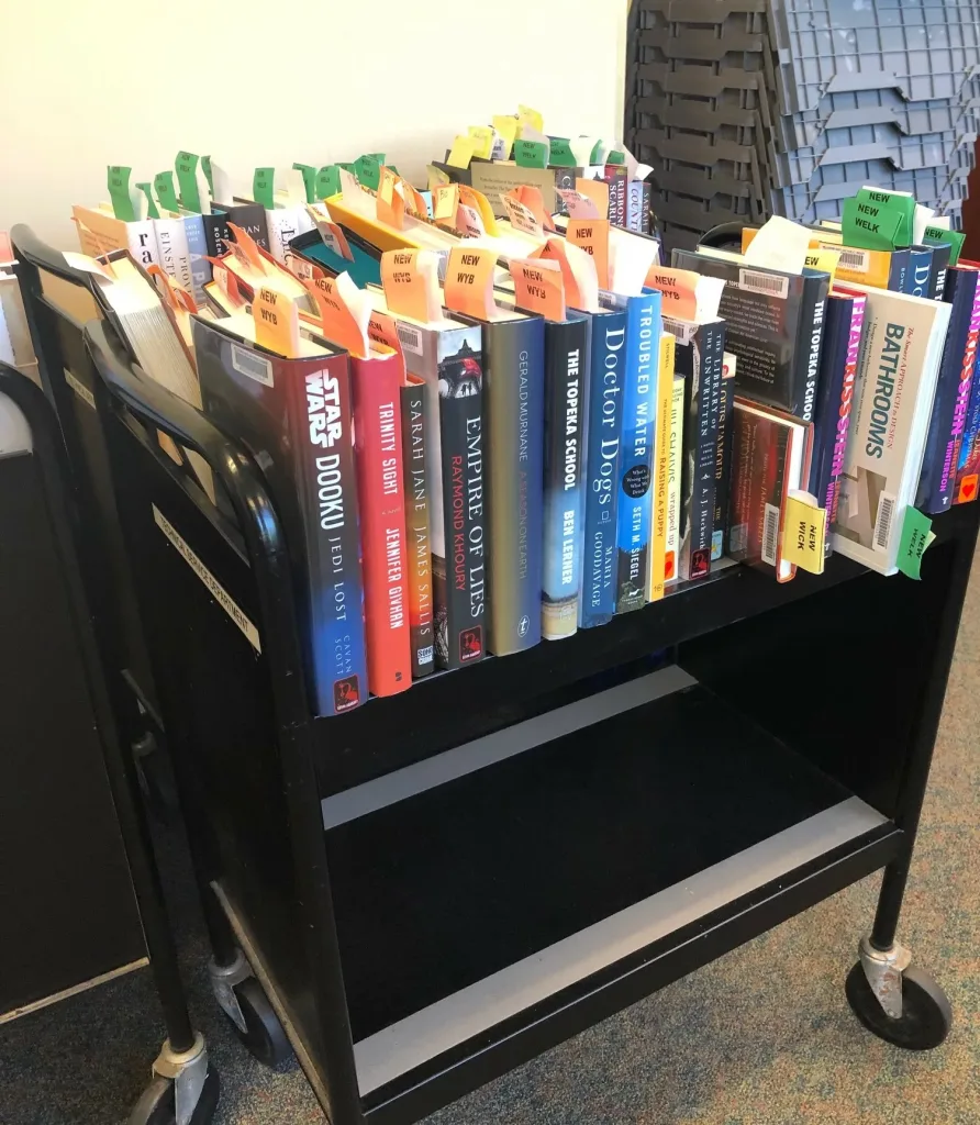 Cart of new books being processed