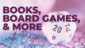 Featured image for the Books, Board Games, & More Blog. Pink background with a twelve-sided die from Dungeons and Dragons.